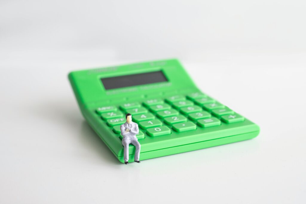 Financial Modeling man sitting on the calculator